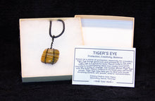 Load image into Gallery viewer, Polished Tiger&#39;s Eye Stone With Black and Gold Wire Wrapping With a Black Cord
